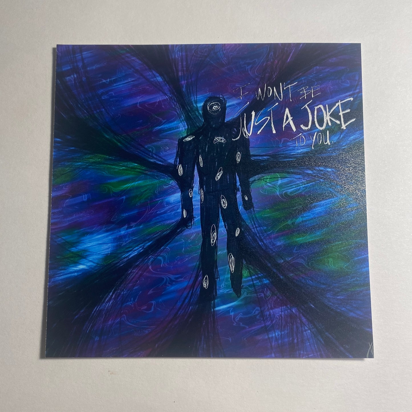 Distorted blue, green , and purple background. 7 bundles of wire-like stalks connecting to an all-black figure in the center with white spots covering him. Text reading "I Won't Be Just a Joke to You."