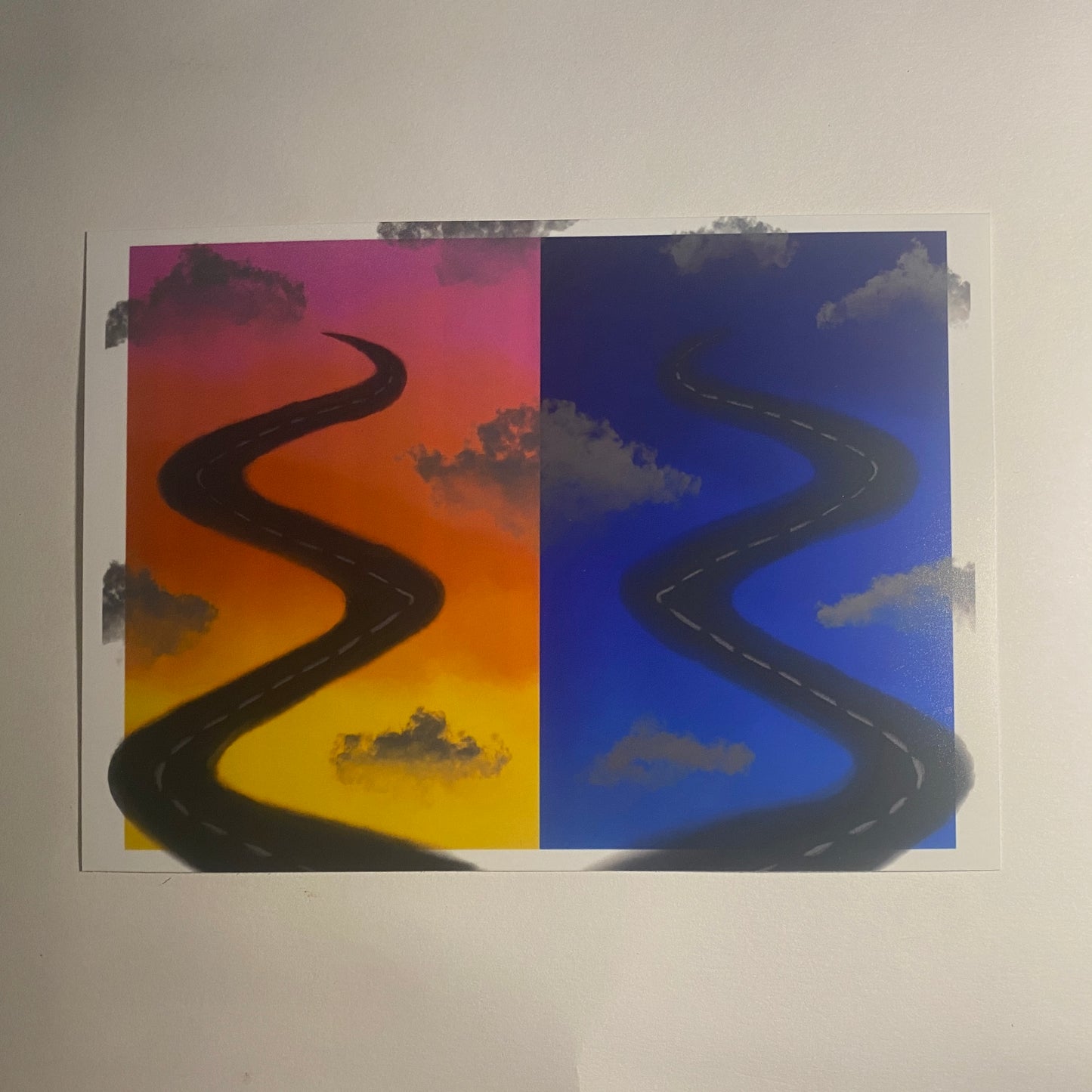 Two wavy roads on a split background of sunset and blue sky with clouds.