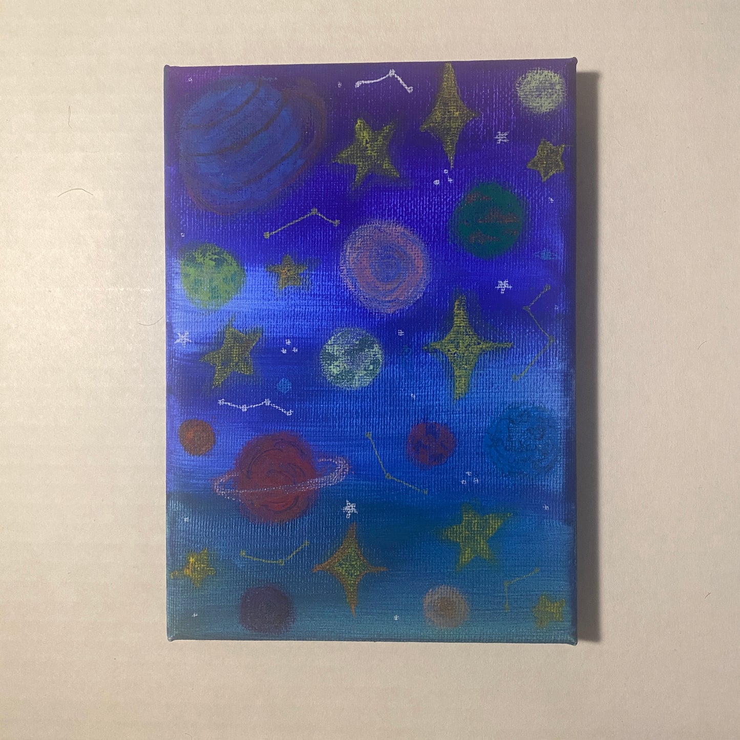 Canvas print with space-themed design featuring planets and stars on a blue background.
